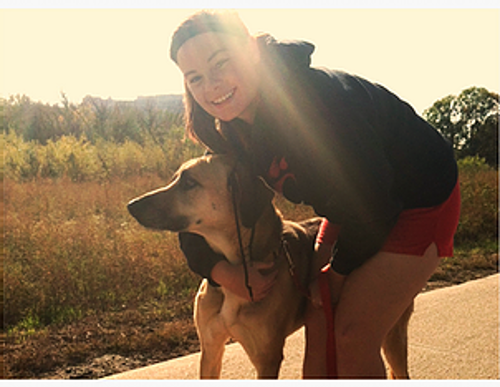 girl hugging dog